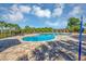 Sparkling community pool surrounded by palm trees, lounge chairs, and a covered pergola at 2426 Addison Creek Dr, Kissimmee, FL 34758