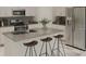 Bright kitchen features stainless steel appliances, an island with bar seating, and ample storage at 2441 Spring Tune Aly, Kissimmee, FL 34744