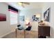 Home office features a glass desk, a comfortable chair, and ample natural light at 2441 Spring Tune Aly, Kissimmee, FL 34744