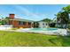 Private backyard featuring a refreshing in-ground pool and manicured green lawn at 2504 Caribbean Ct, Orlando, FL 32805