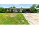 Charming single-story home with a well-maintained lawn and inviting front porch at 2504 Caribbean Ct, Orlando, FL 32805