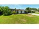 Well-maintained front yard with lush green grass and mature landscaping enhancing curb appeal at 2504 Caribbean Ct, Orlando, FL 32805