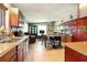 Open-concept kitchen with dark wood cabinets, an island with seating, and stainless steel sink at 2504 Caribbean Ct, Orlando, FL 32805