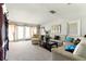 Bright living room with carpet, a white sofa and large windows providing natural light at 2504 Caribbean Ct, Orlando, FL 32805