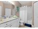 Bright bathroom with a shower-tub combo, white vanity, and neutral tile floors at 2952 Lucayan Harbour Cir # 105, Kissimmee, FL 34746