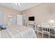 Bright bedroom includes a TV, desk area, and adjacent bathroom for convenience at 2952 Lucayan Harbour Cir # 105, Kissimmee, FL 34746