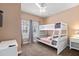 Cozy bedroom featuring a white bunk bed, neutral walls and carpet, and a ceiling fan at 2952 Lucayan Harbour Cir # 105, Kissimmee, FL 34746