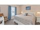Bedroom with a comfy bed, blue curtains, and neutral-toned walls and carpet at 2952 Lucayan Harbour Cir # 105, Kissimmee, FL 34746