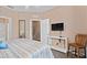 Bedroom with striped bedding, a doorway to the bathroom and neutral carpet at 2952 Lucayan Harbour Cir # 105, Kissimmee, FL 34746