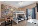 Fun bedroom with a bunk bed, comic wallpaper, foosball table, and neutral carpet at 2952 Lucayan Harbour Cir # 105, Kissimmee, FL 34746