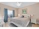 Cozy bedroom featuring natural light, beach-themed decor, and a comfortable bed and nightstands at 2952 Lucayan Harbour Cir # 105, Kissimmee, FL 34746
