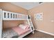 Charming bedroom with a bunk bed and pink accents, perfect for a or guest room at 2952 Lucayan Harbour Cir # 105, Kissimmee, FL 34746