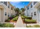 Charming townhomes with a scenic walkway, lush landscaping and palm trees at 2952 Lucayan Harbour Cir # 105, Kissimmee, FL 34746