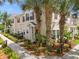 Inviting townhome with lush landscaping and mature palm trees providing shade and curb appeal at 2952 Lucayan Harbour Cir # 105, Kissimmee, FL 34746