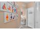 Hallway decorated with cartoon canvases leading to the bedroom and laundry room at 2952 Lucayan Harbour Cir # 105, Kissimmee, FL 34746