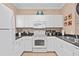 Bright kitchen with white cabinets, granite countertops, and modern appliances for cooking enthusiasts at 2952 Lucayan Harbour Cir # 105, Kissimmee, FL 34746
