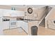 Well-equipped kitchen with white cabinetry, granite countertops, and bar seating for casual dining at 2952 Lucayan Harbour Cir # 105, Kissimmee, FL 34746