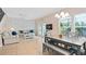 Open concept living room and dining area with a modern table and access to the outdoor patio at 2952 Lucayan Harbour Cir # 105, Kissimmee, FL 34746
