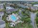 Aerial view of a community pool, nearby lake, and various well-maintained community buildings at 3561 Conroy Rd # 216, Orlando, FL 32839