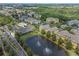 Aerial shot of the community, showcasing a lake, pool, and lush landscaping at 3561 Conroy Rd # 216, Orlando, FL 32839