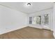 Bedroom featuring wood-look floors, natural light, and a sliding glass door at 3561 Conroy Rd # 216, Orlando, FL 32839
