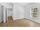 Bright bedroom featuring wood-look floors, large window and walk-in closet at 3561 Conroy Rd # 216, Orlando, FL 32839