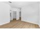 Bright, empty bedroom featuring wood-look floors and closet at 3561 Conroy Rd # 216, Orlando, FL 32839