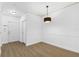 Neutral entryway featuring a front door, wood-look flooring, and modern lighting at 3561 Conroy Rd # 216, Orlando, FL 32839