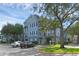 A three-story blue condo building with ample parking and mature trees at 3561 Conroy Rd # 216, Orlando, FL 32839