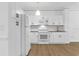 Modern kitchen with white cabinets, stainless steel appliances, and wood flooring at 3561 Conroy Rd # 216, Orlando, FL 32839
