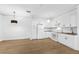 Bright eat-in kitchen with white cabinetry, modern appliances and wood-look flooring at 3561 Conroy Rd # 216, Orlando, FL 32839