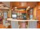 Lounge kitchenette with a bar, mini-fridge, microwave, coffee, and plaid chairs at 3561 Conroy Rd # 216, Orlando, FL 32839