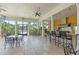 Outdoor kitchen with pool view featuring ample seating and a built-in grill at 3561 Conroy Rd # 216, Orlando, FL 32839