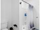 White bathroom features a stand-up shower, toilet, and minimalist black hardware at 3624 Sungrove Cir, Sanford, FL 32771
