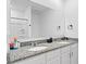 Bathroom featuring granite countertops, dual sinks, a large mirror, and a stand-up shower at 3624 Sungrove Cir, Sanford, FL 32771