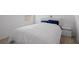 Bedroom featuring plush carpeting, a white comforter, and a white bedside table at 3624 Sungrove Cir, Sanford, FL 32771