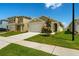 Well-maintained home with a two-car garage, and landscaped front yard under a bright blue sky at 3624 Sungrove Cir, Sanford, FL 32771