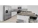 Bright kitchen features stainless steel appliances, granite counters and a breakfast bar with seating for two at 3624 Sungrove Cir, Sanford, FL 32771
