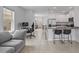 Open-concept living space with kitchen, dining, and living areas, featuring tile flooring and stainless steel appliances at 3624 Sungrove Cir, Sanford, FL 32771