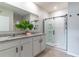 Bright bathroom featuring double sinks, granite countertop, white cabinets, and glass-enclosed shower at 3723 Alder Bark Ln, Sanford, FL 32773