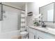Charming bathroom with modern fixtures, granite countertop, white cabinets and tub with shower at 3723 Alder Bark Ln, Sanford, FL 32773