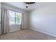 Comfortable bedroom featuring a ceiling fan and a sunny window with curtains at 3723 Alder Bark Ln, Sanford, FL 32773