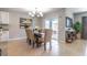Elegant dining area with stylish chandelier, seating for six, and sliding glass doors to the lanai at 3723 Alder Bark Ln, Sanford, FL 32773