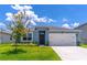 Charming one-story home featuring a two-car garage, well-maintained lawn, and inviting curb appeal at 3723 Alder Bark Ln, Sanford, FL 32773