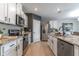 Stylish kitchen features granite counters, stainless appliances, a center island, and white cabinetry at 3723 Alder Bark Ln, Sanford, FL 32773