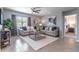 Comfortable living room featuring neutral décor, plush seating, and a view into an adjacent bedroom at 3723 Alder Bark Ln, Sanford, FL 32773