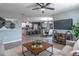 Cozy living room with tile floors, ceiling fan, and open floorplan to kitchen and dining areas at 3723 Alder Bark Ln, Sanford, FL 32773