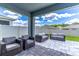 Outdoor patio area features comfortable patio furniture and a stone tile floor at 3723 Alder Bark Ln, Sanford, FL 32773