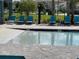 Community pool with shallow areas, surrounded by lounge chairs and umbrellas for sunny relaxation at 3723 Alder Bark Ln, Sanford, FL 32773