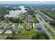 Expansive aerial shot showcasing houses with well-manicured lawns and a tranquil lake nearby at 3865 W Stillwood Ln, Lake Mary, FL 32746
